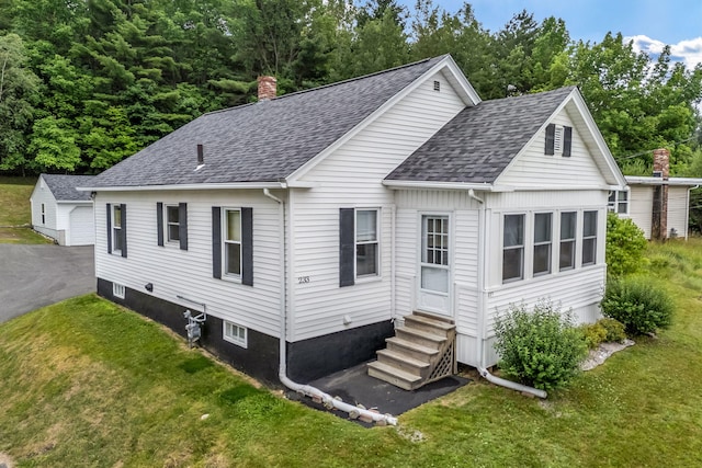 233 Northern Ave, Augusta, ME 04330 - back of house featuring entry steps, a shingled roof, and a lawn