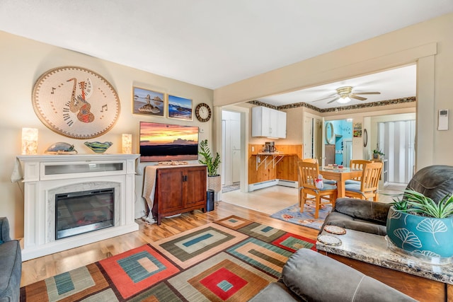 233 Northern Ave, Augusta, ME 04330 - living area with light wood-style floors, a ceiling fan, baseboard heating, and a high end fireplace