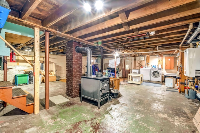 233 Northern Ave, Augusta, ME 04330 - unfinished below grade area featuring washing machine and dryer and a wood stove