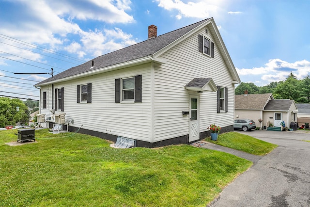233 Northern Ave, Augusta, ME 04330 - view of side of property featuring a chimney, a yard, and roof with shingles