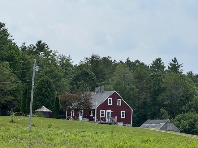 152 Cross Rd, Alna, ME 04535 - view of front of house with a front yard and a view of trees