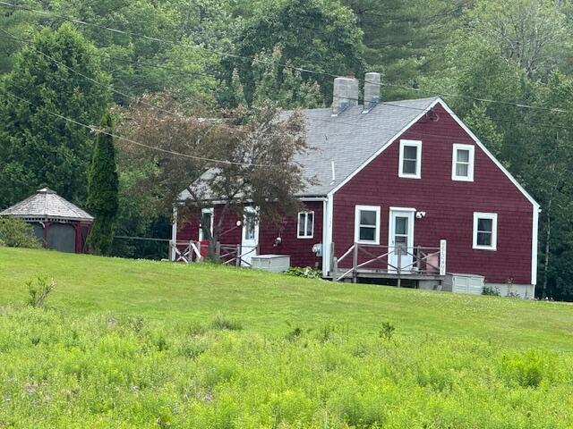 152 Cross Rd, Alna, ME 04535 - rear view of house featuring a chimney, a lawn, and roof with shingles