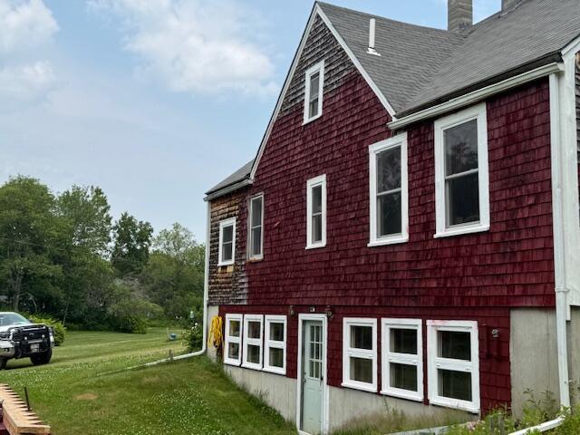 152 Cross Rd, Alna, ME 04535 - view of property exterior featuring a yard, a shingled roof, and a chimney