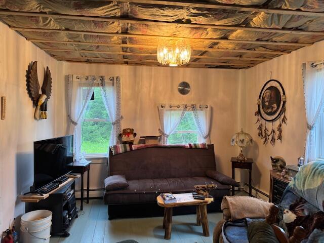 152 Cross Rd, Alna, ME 04535 - living area with plenty of natural light, a baseboard heating unit, and wood finished floors