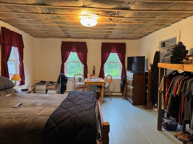 152 Cross Rd, Alna, ME 04535 - bedroom featuring wood-type flooring and a baseboard heating unit