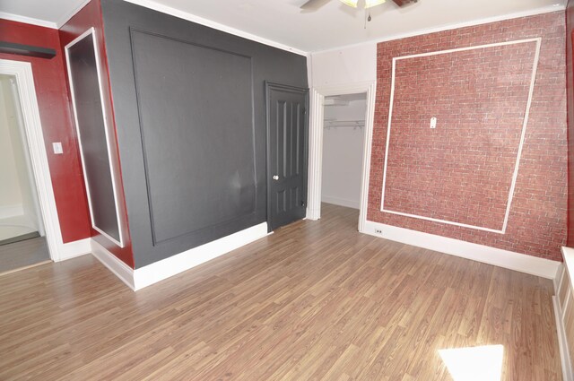 56 Holyoke St, Brewer, ME 04412 - spare room featuring light wood-style flooring, ceiling fan, brick wall, and ornamental molding