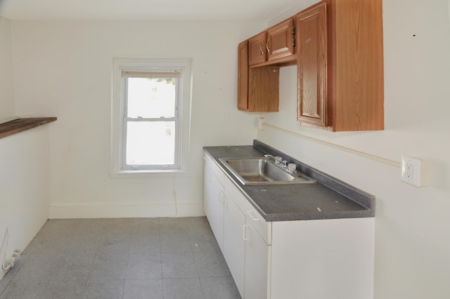 56 Holyoke St, Brewer, ME 04412 - kitchen featuring dark countertops and brown cabinetry