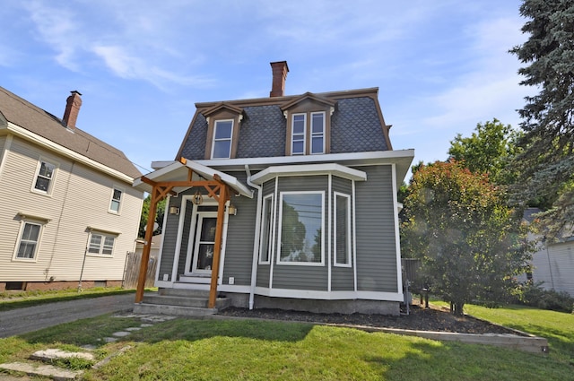 56 Holyoke St, Brewer, ME 04412 - second empire-style home featuring mansard roof, a front yard, and a chimney