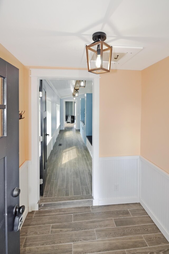 56 Holyoke St, Brewer, ME 04412 - hallway with wainscoting, wood finished floors, and a chandelier