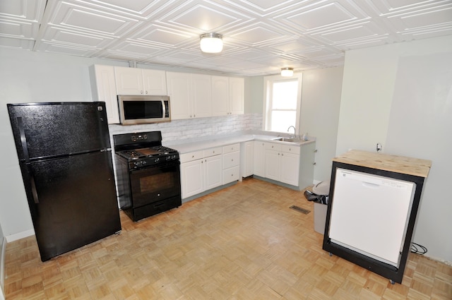 56 Holyoke St, Brewer, ME 04412 - kitchen with black appliances, white cabinets, decorative backsplash, and an ornate ceiling