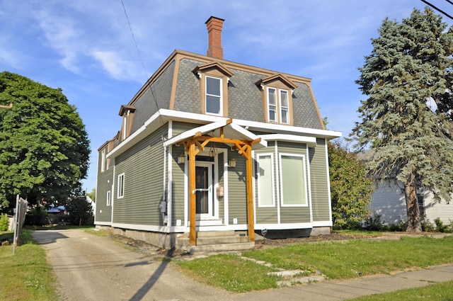 56 Holyoke St, Brewer, ME 04412 - second empire-style home featuring a chimney, mansard roof, a front lawn, and asphalt driveway