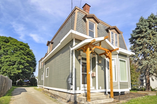 56 Holyoke St, Brewer, ME 04412 - view of front of house featuring a chimney and mansard roof