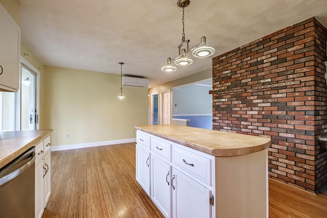 704 Brighton Hill Rd, Minot, ME 04258 - kitchen featuring stainless steel dishwasher, an AC wall unit, light wood-type flooring, brick wall, and decorative light fixtures