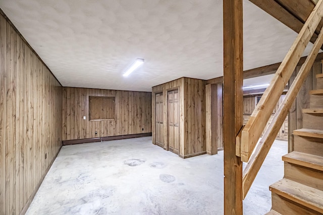 704 Brighton Hill Rd, Minot, ME 04258 - finished basement with wooden walls, stairway, and a textured ceiling