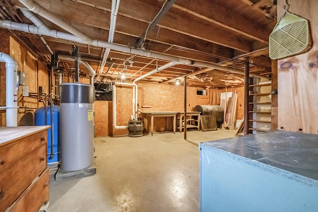 704 Brighton Hill Rd, Minot, ME 04258 - unfinished basement with water heater, a water pressure tank, and heating fuel