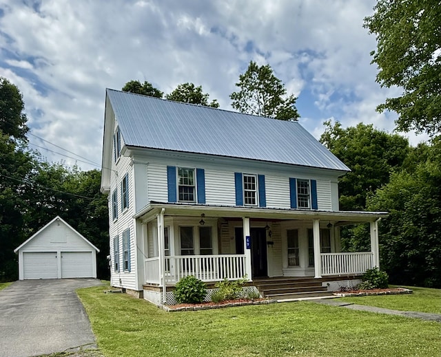 69 Lafayette St, Calais, ME 04619 - view of front facade with a detached garage, an outdoor structure, covered porch, a metal roof, and a front yard