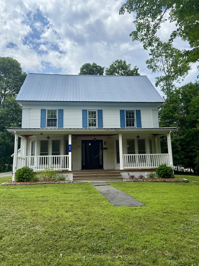 69 Lafayette St, Calais, ME 04619 - country-style home with covered porch, a metal roof, and a front yard
