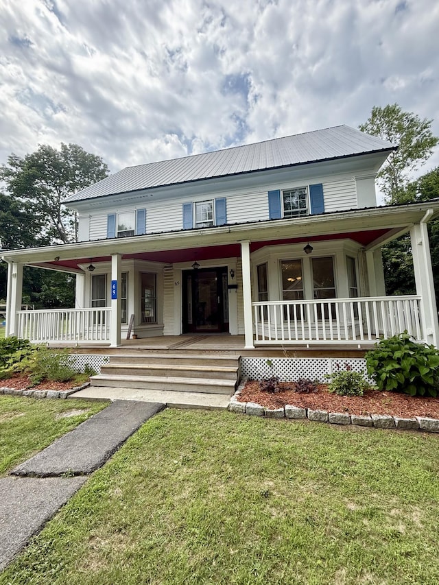 69 Lafayette St, Calais, ME 04619 - farmhouse featuring a porch, a metal roof, and a front yard