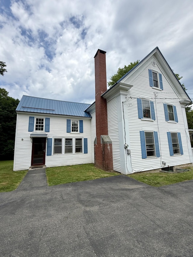 69 Lafayette St, Calais, ME 04619 - view of front of home featuring a chimney and a metal roof