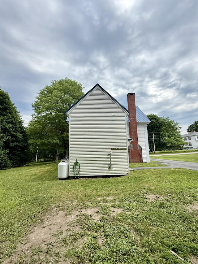 69 Lafayette St, Calais, ME 04619 - view of home's exterior with a yard and a chimney