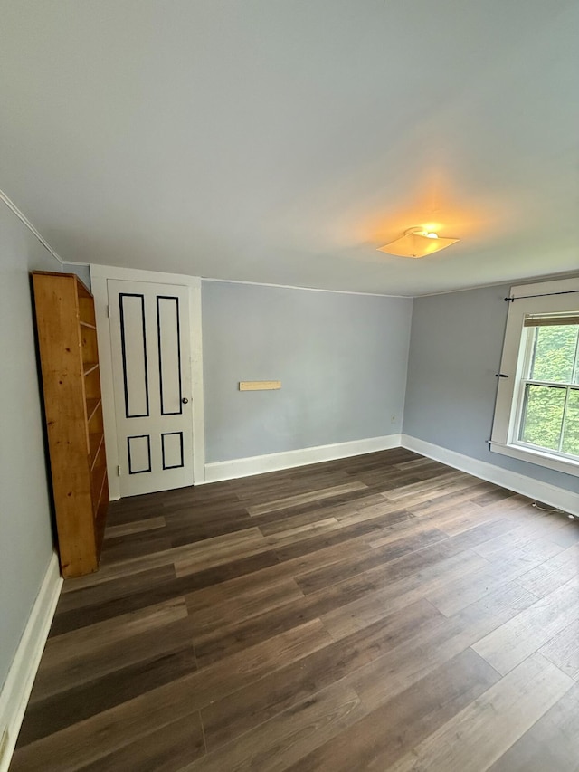 69 Lafayette St, Calais, ME 04619 - empty room with dark wood-type flooring and baseboards