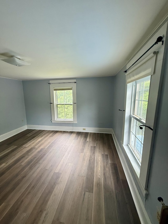 69 Lafayette St, Calais, ME 04619 - spare room with dark wood-style floors and healthy amount of natural light