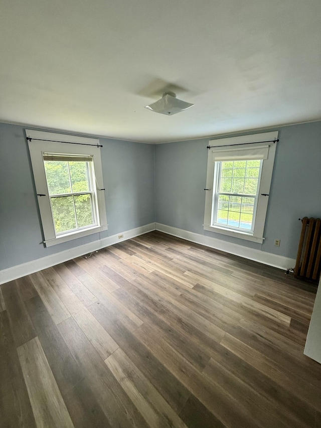 69 Lafayette St, Calais, ME 04619 - unfurnished room with healthy amount of natural light and dark wood-style floors