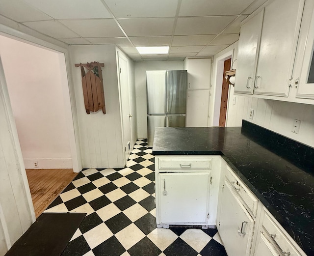 69 Lafayette St, Calais, ME 04619 - kitchen featuring light floors, freestanding refrigerator, a peninsula, a drop ceiling, and dark countertops