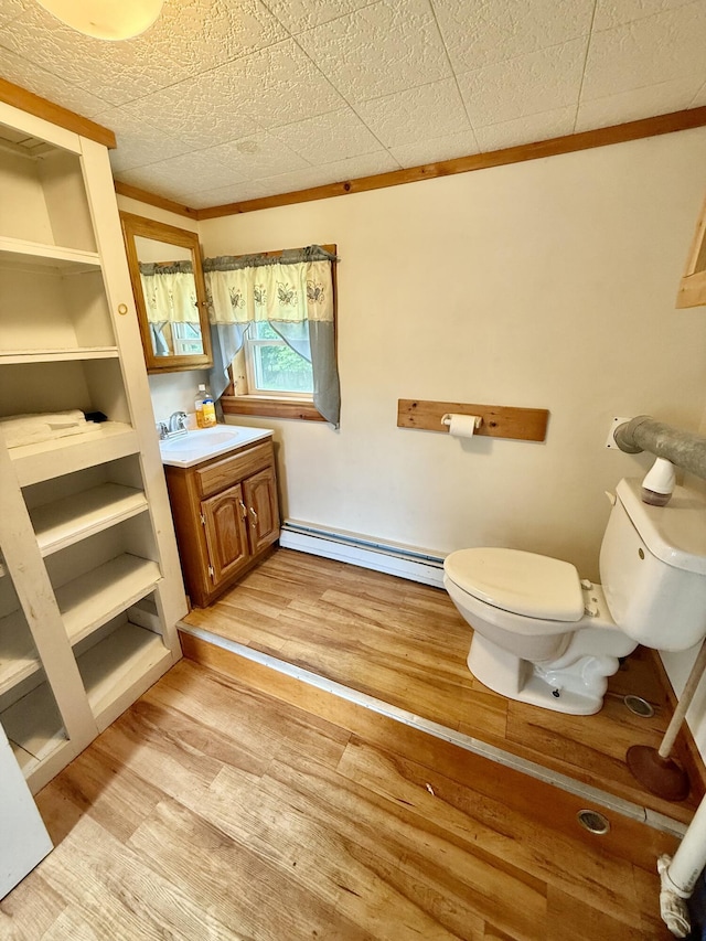 69 Lafayette St, Calais, ME 04619 - bathroom with a baseboard radiator, vanity, and wood finished floors