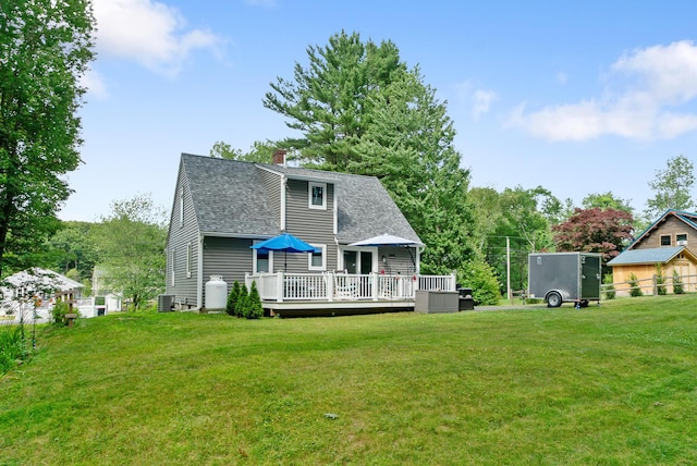 68 Appletree Ln, Wells, ME 04090 - rear view of property featuring a wooden deck, a chimney, roof with shingles, and a lawn