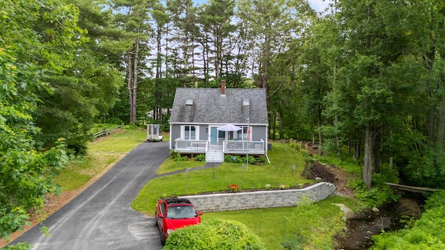 68 Appletree Ln, Wells, ME 04090 - view of front of property featuring a deck, a shingled roof, and a front lawn