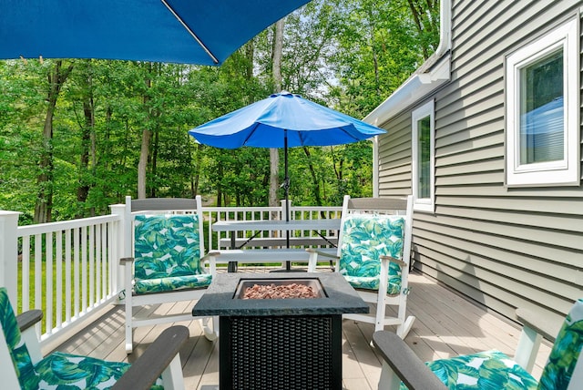 68 Appletree Ln, Wells, ME 04090 - deck with a fire pit and view of wooded area