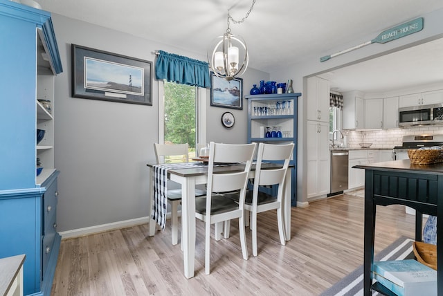 68 Appletree Ln, Wells, ME 04090 - dining area with a chandelier and light wood finished floors