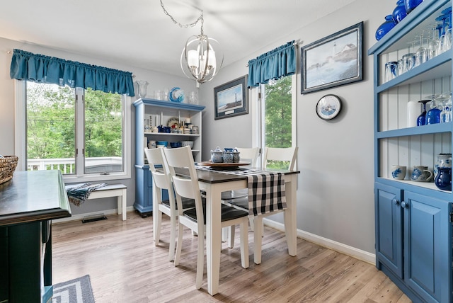68 Appletree Ln, Wells, ME 04090 - dining area featuring a chandelier and light wood finished floors