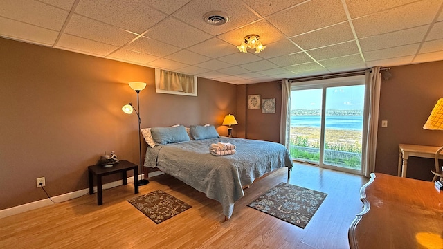 9 County Rd, Lubec, ME 04652 - bedroom featuring a paneled ceiling, access to exterior, wood finished floors, and a water view