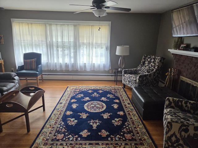 125 Connecticut Ave, Millinocket, ME 04462 - living room featuring a ceiling fan, baseboard heating, wood finished floors, and a fireplace