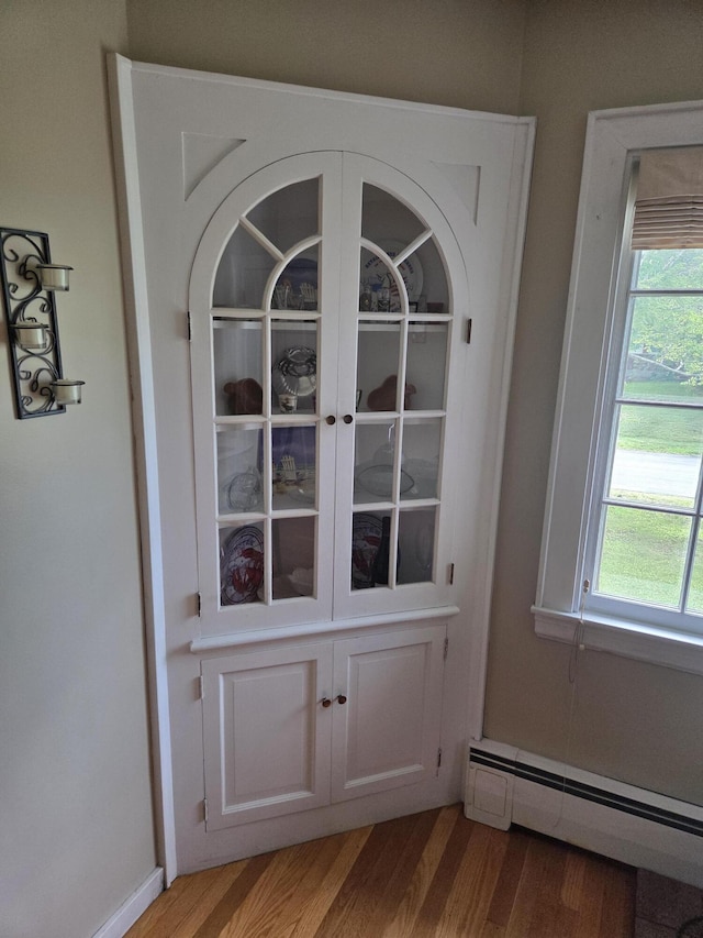125 Connecticut Ave, Millinocket, ME 04462 - detailed view of a baseboard radiator and wood finished floors