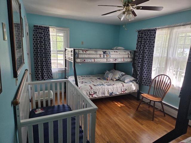 125 Connecticut Ave, Millinocket, ME 04462 - bedroom featuring wood finished floors, a ceiling fan, and a baseboard heating unit