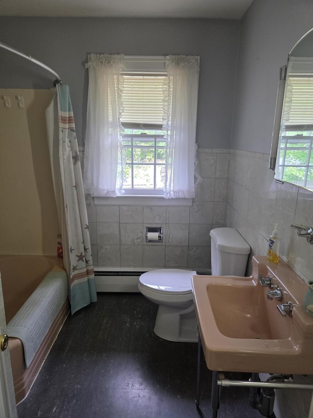 125 Connecticut Ave, Millinocket, ME 04462 - full bathroom featuring a baseboard heating unit, tile walls, a wainscoted wall, and shower / bath combo with shower curtain