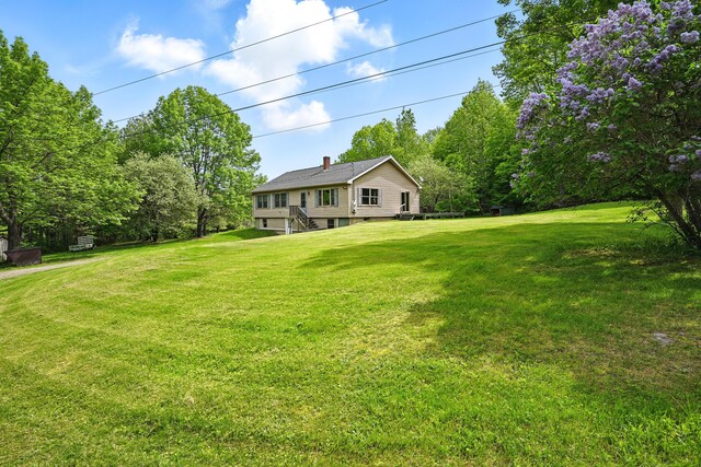 23 Mccutcheon Way, Sidney, ME 04330 - view of front of house featuring a front lawn and a chimney