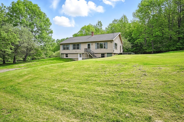 23 Mccutcheon Way, Sidney, ME 04330 - back of property featuring a lawn, a chimney, and stairway