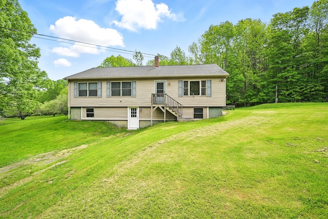 23 Mccutcheon Way, Sidney, ME 04330 - back of property with a chimney and a yard