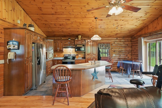 23 Mccutcheon Way, Sidney, ME 04330 - kitchen featuring appliances with stainless steel finishes, vaulted ceiling, log walls, wood ceiling, and light countertops