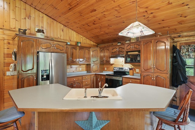 23 Mccutcheon Way, Sidney, ME 04330 - kitchen with appliances with stainless steel finishes, vaulted ceiling, a kitchen breakfast bar, wood walls, and under cabinet range hood