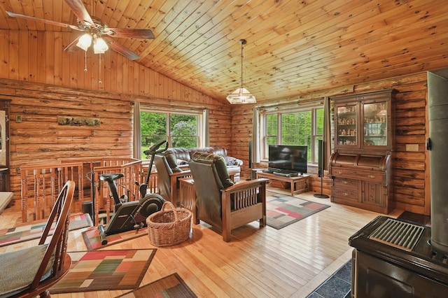 23 Mccutcheon Way, Sidney, ME 04330 - living area featuring vaulted ceiling, wood ceiling, rustic walls, healthy amount of natural light, and hardwood / wood-style floors