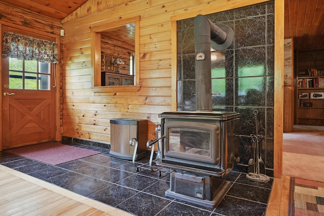 23 Mccutcheon Way, Sidney, ME 04330 - foyer entrance with lofted ceiling, a wood stove, wood walls, and wooden ceiling