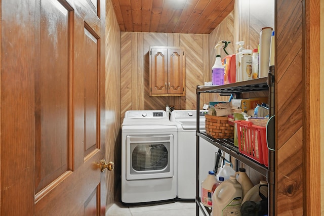 23 Mccutcheon Way, Sidney, ME 04330 - laundry area with wood walls, cabinet space, washing machine and dryer, wood ceiling, and light tile patterned flooring
