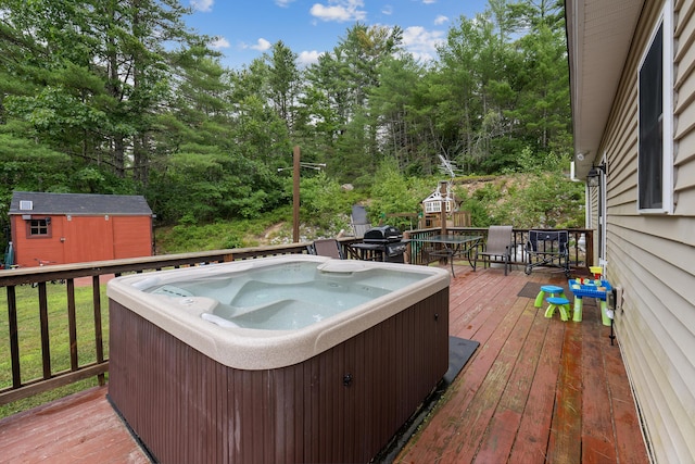504 Balch Mill Rd, Newfield, ME 04095 - wooden terrace featuring a hot tub, a shed, outdoor dining space, a grill, and view of scattered trees