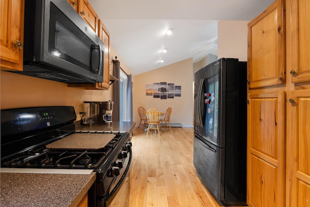 504 Balch Mill Rd, Newfield, ME 04095 - kitchen with black appliances, dark countertops, vaulted ceiling, light wood-type flooring, and brown cabinetry