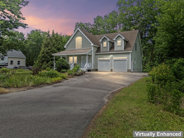 17 Tuttle Ln, Wells, ME 04090 - view of front facade with asphalt driveway, covered porch, and an attached garage